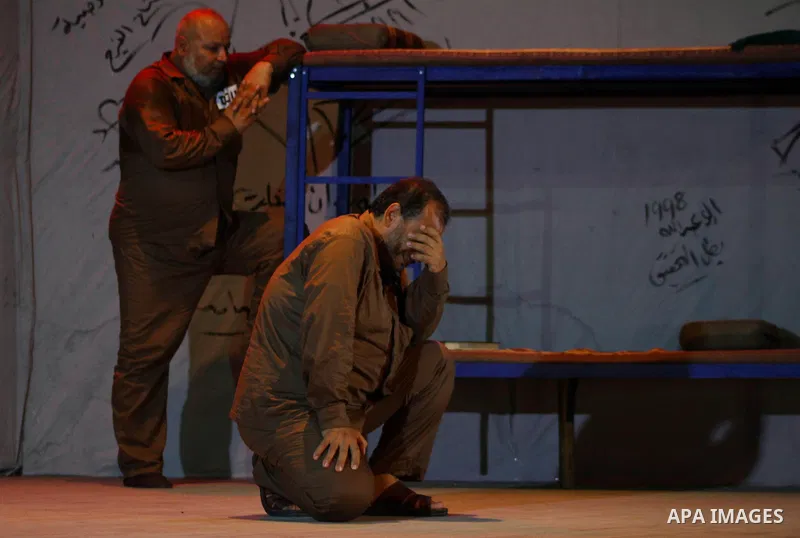 Palestinian actors perform at al-Shawwa theatre a play appear the hard life of Palestinian prisoners inside the Israeli jails, in Gaza city on Sep 3,2011. About 7,500 Palestinian prisoners are held in Israeli jails, acco...