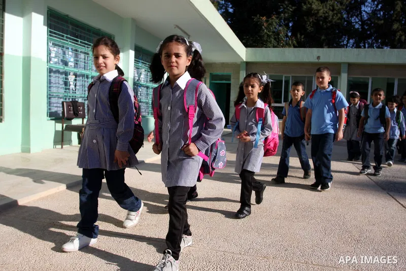 Palestinian students return back to their school in the morning of the first day of the new year study in the West Bank city of Ramallah on Sep. 4, 2011. Photo by Issam Rimawi