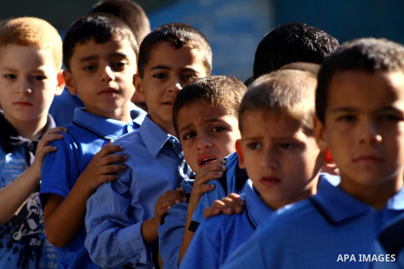 Palestinian students return back to their school in the morning of the first day of the new year study in Gaza city on Sep. 4, 2011. Photo by Ashraf Amra
