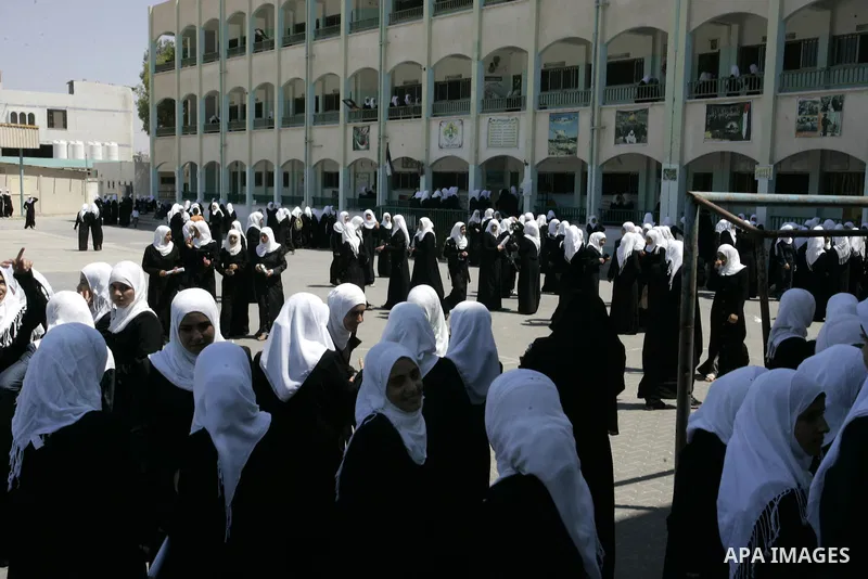 Palestinian students return back to their school in the morning of the first day of the new year study in Rafah, southern Gaza Strip on Sep. 4, 2011. Photo by Abed Rahim Khatib