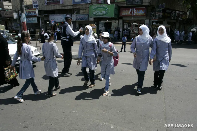 Palestinian students return back to their school in the morning of the first day of the new year study in Rafah, southern Gaza Strip on Sep. 4, 2011. Photo by Abed Rahim Khatib