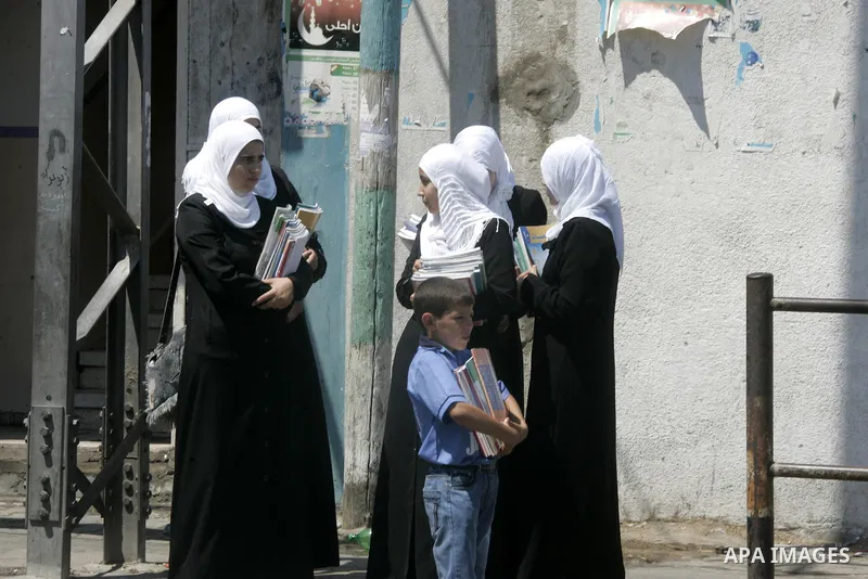 Palestinian students return back to their school in the morning of the first day of the new year study in Rafah, southern Gaza Strip on Sep. 4, 2011. Photo by Abed Rahim Khatib