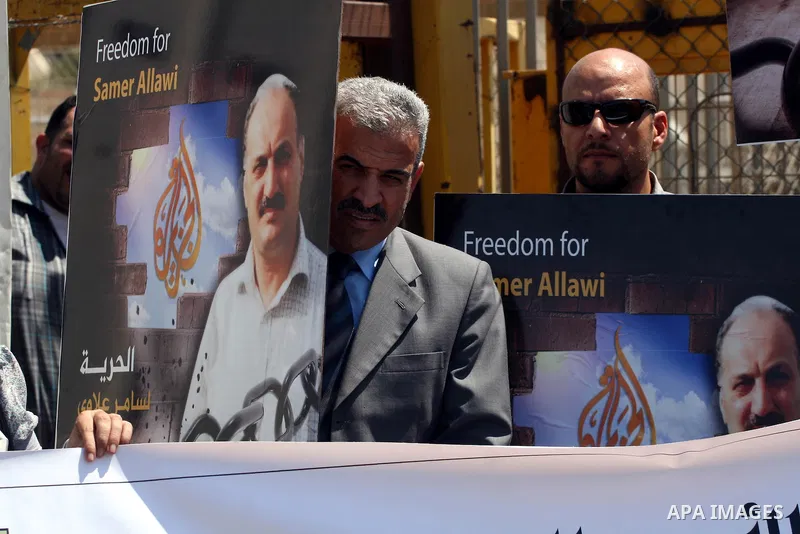 Palestinian activists take part in a protest calling for the release of the Palestinian journalist, Samer Allawi in the West Bank city of Ramallah, Sept. 4, 2011. Allawi, the chief of al-Jazeera TV bureau in Afghanistan,...