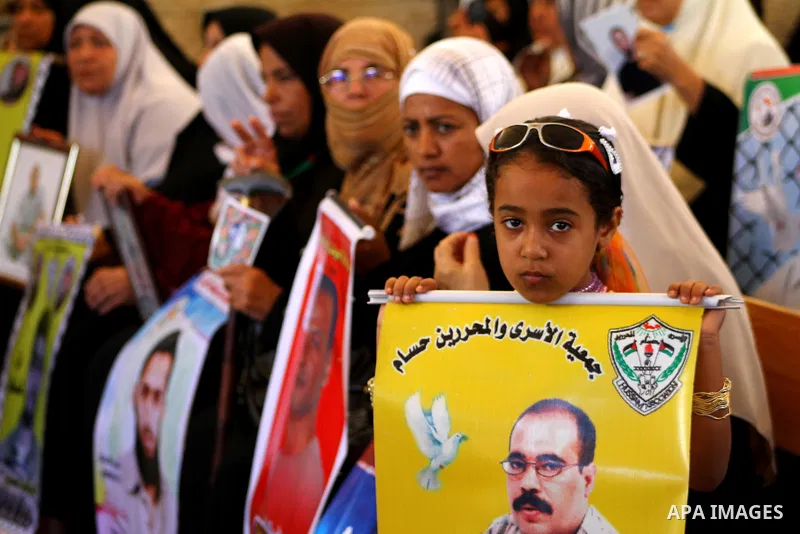 Palestinians hold pictures of their prisoned relatives in Israeli jails as they gather in a weekly activity calling for their liberty at the Red Cross headquarters in Gaza City onSep. 5, 2011. About 7000 prisoners are in...