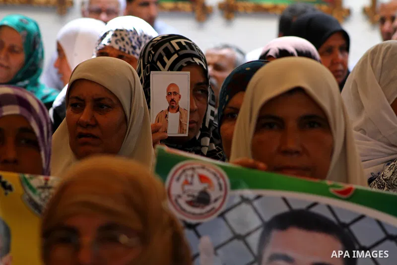 Palestinian women hold pictures of their prisoned relatives in Israeli jails as they gather in a weekly activity calling for their liberty at the Red Cross headquarters in Gaza City onSep. 5, 2011. About 7000 prisoners a...