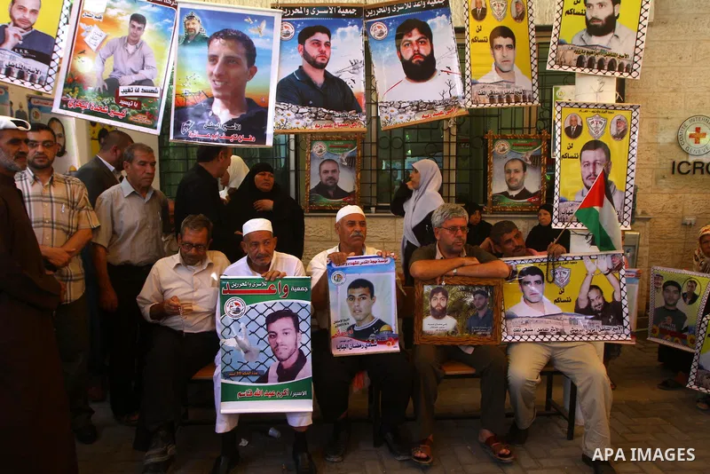 Palestinian women hold pictures of their prisoned relatives in Israeli jails as they gather in a weekly activity calling for their liberty at the Red Cross headquarters in Gaza City onSep. 5, 2011. About 7000 prisoners a...