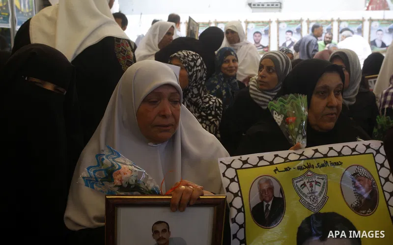 Palestinian women hold pictures of their prisoned relatives in Israeli jails as they gather in a weekly activity calling for their liberty at the Red Cross headquarters in Gaza City onSep. 5, 2011. About 7000 prisoners a...