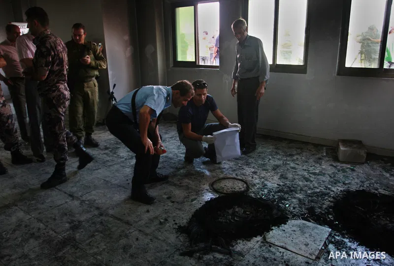 Palestinians and Palestinian security forces inspect the damage inside a mosque torched and vandalized by arsonists in the West Bank village of Qusra, near Nablus, Monday, Sept. 5, 2011. Arsonists tossed two tires into t...