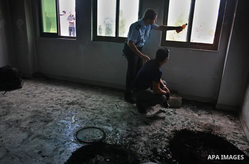Palestinians and Palestinian security forces inspect the damage inside a mosque torched and vandalized by arsonists in the West Bank village of Qusra, near Nablus, Monday, Sept. 5, 2011. Arsonists tossed two tires into t...