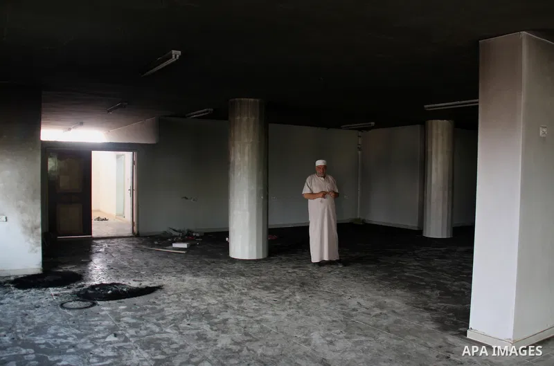 A Palestinian man stands inside a damaged mosque in the West Bank village of Qusra, near Nablus September 5, 2011. Jewish settlers set fire to part of the mosque in the occupied West Bank on Monday, Palestinians said, an...