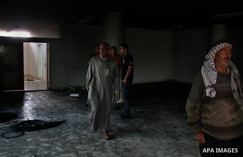 Palestinians inspect the damage inside a mosque torched and vandalized by arsonists in the West Bank village of Qusra, near Nablus, on Sept. 5, 2011. Arsonists tossed tow tires into the first floor study hall of a new mo...