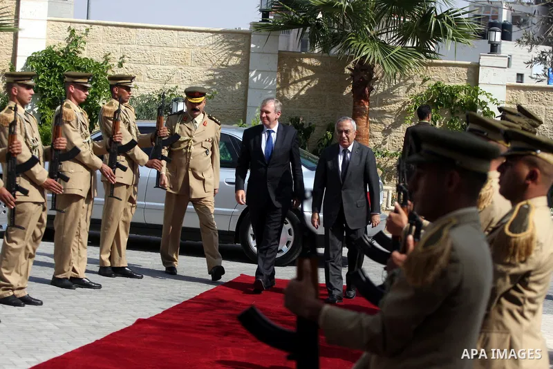 Palestinian Prime Minister Salam Fayyad reviews an honour guard with his Belgian counterpart Yves Leterme upon the latter's arrival in the West Bank city of Ramallah on September 5, 2011, a day after Palestinian official...