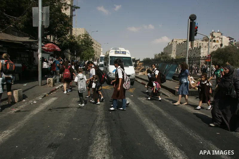 Palestinian students walk in a street after they returned back from their school on the second day of the new studing year, in Jerusalem's old city on Sep. 5,2011. Photo by Mahfouz Abu Turk