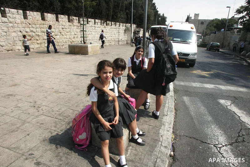 Palestinian students wait in a street after they returned back from their school on the second day of the new studing year, in Jerusalem's old city on Sep. 5,2011. Photo by Mahfouz Abu Turk