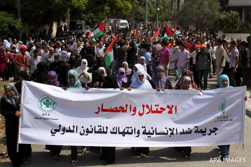 Palestinians of the Union of Agricultural Work Committees take part in a protest in front of UNRWA headquarters, to object about the Palmer report in Gaza city on Sep. 6, 2011 . Photo by Mohammed Asad