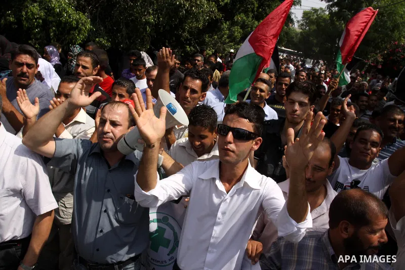 Palestinians of the Union of Agricultural Work Committees take part in a protest in front of UNRWA headquarters, to object about the Palmer report in Gaza city on Sep. 6, 2011 . Photo by Mohammed Asad