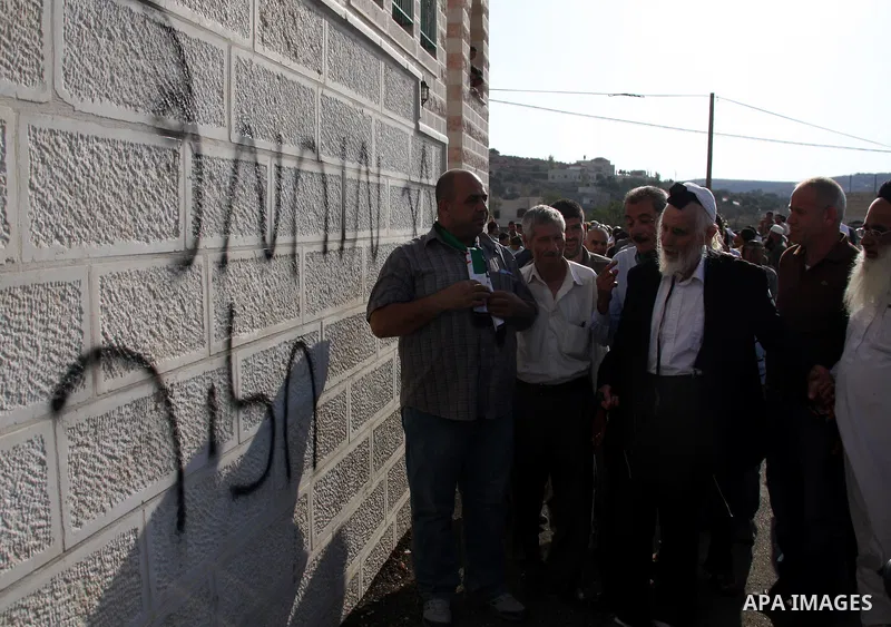Jewish rabbi Menachem Froman leads a reconciliation visit of Jewish settlers to the West Bank village of Qusra, a day after the local mosque was vandalized, Tuesday, Sept. 6, 2011. The mosque was torched Monday after Isr...