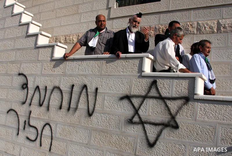 Jewish rabbi Menachem Froman leads a reconciliation visit of Jewish settlers to the West Bank village of Qusra, a day after the local mosque was vandalized, Tuesday, Sept. 6, 2011. The mosque was torched Monday after Isr...