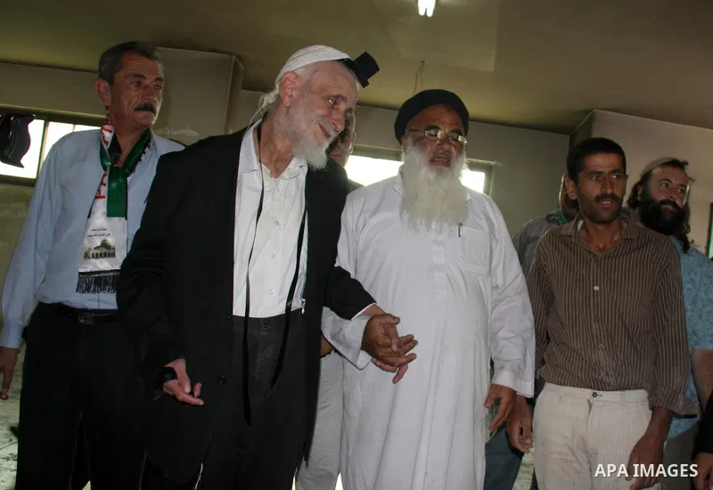 Jewish rabbi Menachem Froman leads a reconciliation visit of Jewish settlers to the West Bank village of Qusra, a day after the local mosque was vandalized, Tuesday, Sept. 6, 2011. The mosque was torched Monday after Isr...