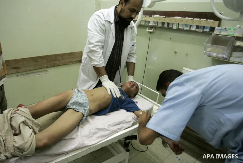 A wounded Palestinian boy receives medical care on September 6, 2011 at a hospital in Khan Yunis, following an Israeli air strike east of the central Gaza Strip city in which a Palestinian militant was killed and three c...