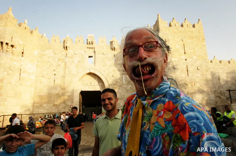 A Spanish clown demonstrates his skills in front of Palestinian children at the market near Damscus gate in Jerusalem's old city on Sep. 6,2011. Photo by Mahfouz Abu Turk