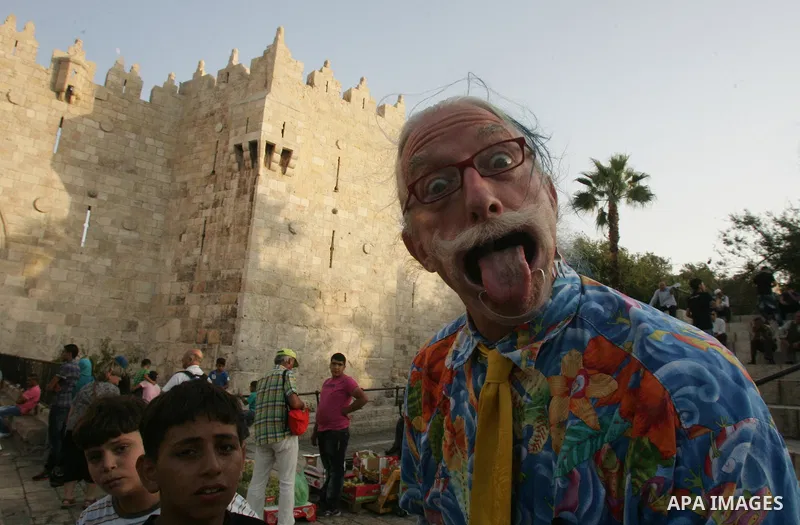 A Spanish clown demonstrates his skills in front of Palestinian children at the market near Damscus gate in Jerusalem's old city on Sep. 6,2011. Photo by Mahfouz Abu Turk