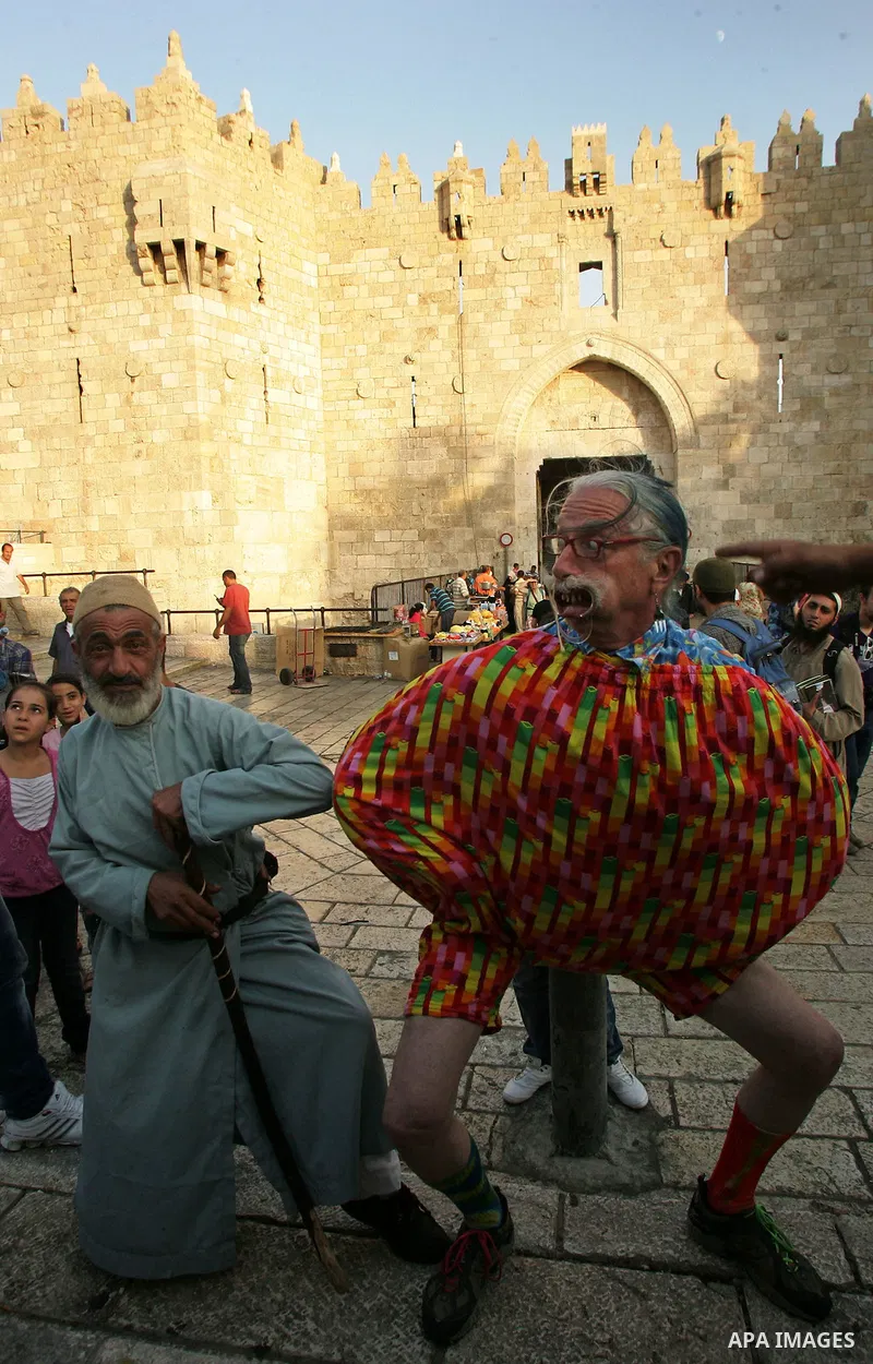 A Spanish clown demonstrates his skills in front of Palestinian children at the market near Damscus gate in Jerusalem's old city on Sep. 6,2011. Photo by Mahfouz Abu Turk