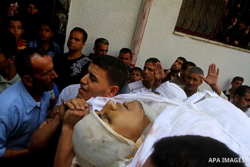 Palestinian mourners carry the body of the Popular Resistance Committees militant, Khaled Abu Samhoud, who was killed in Israeli airstrike, during his funeral in the southern Gaza Strip city of Khan Younis, Sept. 7, 2011...