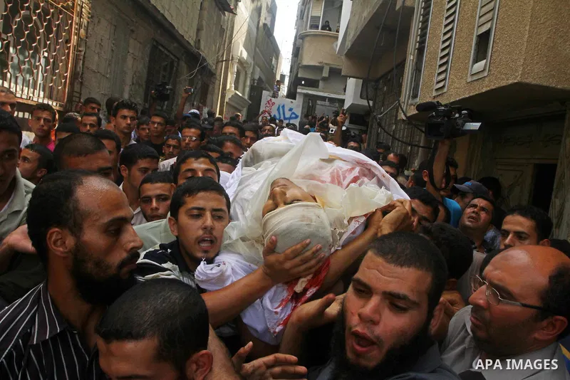 Palestinian mourners carry the body of the Popular Resistance Committees militant, Khaled Abu Samhoud, who was killed in Israeli airstrike, during his funeral in the southern Gaza Strip city of Khan Younis, Sept. 7, 2011...