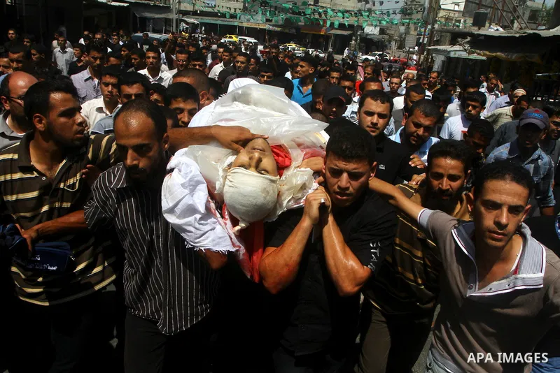 Palestinian mourners carry the body of the Popular Resistance Committees militant, Khaled Abu Samhoud, who was killed in Israeli airstrike, during his funeral in the southern Gaza Strip city of Khan Younis, Sept. 7, 2011...