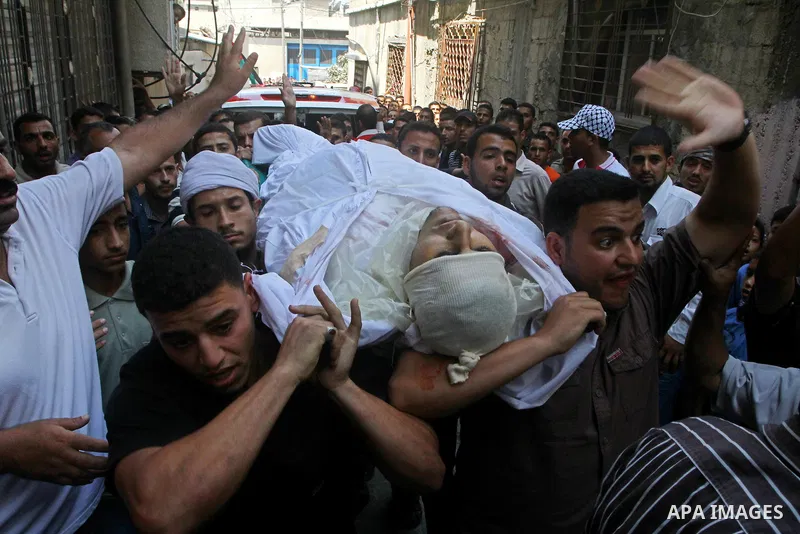 Palestinian mourners carry the body of the Popular Resistance Committees militant, Khaled Abu Samhoud, who was killed in Israeli airstrike, during his funeral in the southern Gaza Strip city of Khan Younis, Sept. 7, 2011...