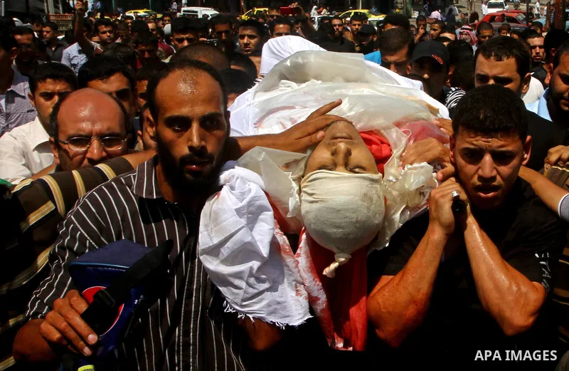 Palestinian mourners carry the body of the Popular Resistance Committees militant, Khaled Abu Samhoud, who was killed in Israeli airstrike, during his funeral in the southern Gaza Strip city of Khan Younis, Sept. 7, 2011...