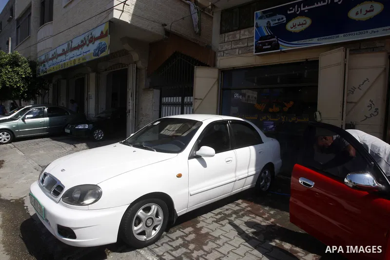 A Palestinian man inspects the cars, at a showroom in Gaza City on Sep. 7, 2011. while Israel stop to enter cars into Gaza Strip again after it allowed to enter them as a part of a new strategy to increase Gaza blockade....