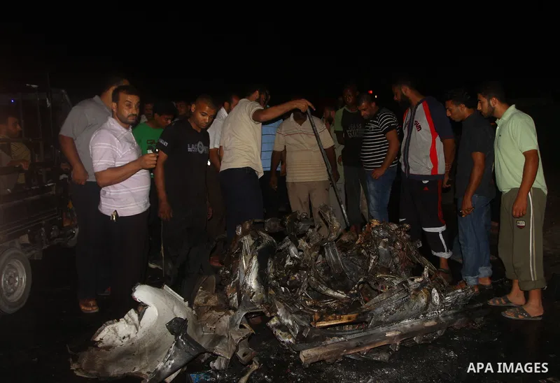 Palestinians check the damage to a car after an Israeli attack in Deir al-Balah in the central Gaza Strip on September 7, 2011. The hardline Islamic Jihad group said that the dead man, Remah al-Hasani, was a member of it...
