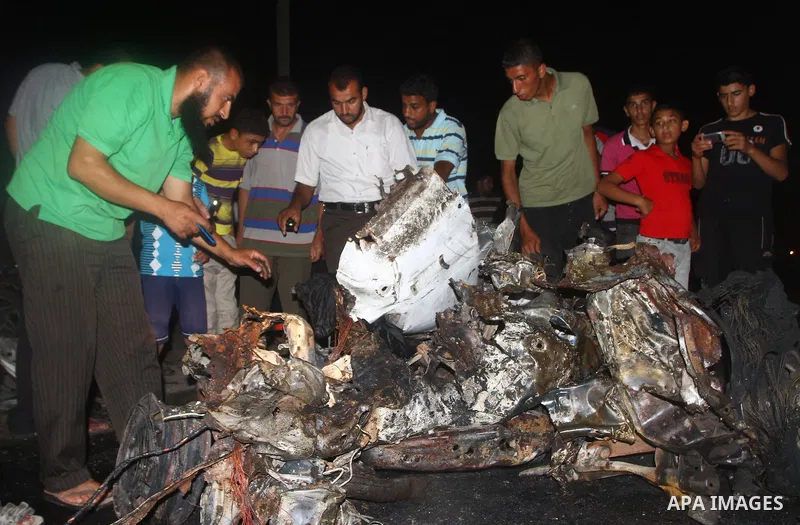 Palestinians check the damage to a car after an Israeli attack in Deir al-Balah in the central Gaza Strip on September 7, 2011. The hardline Islamic Jihad group said that the dead man, Remah al-Hasani, was a member of it...