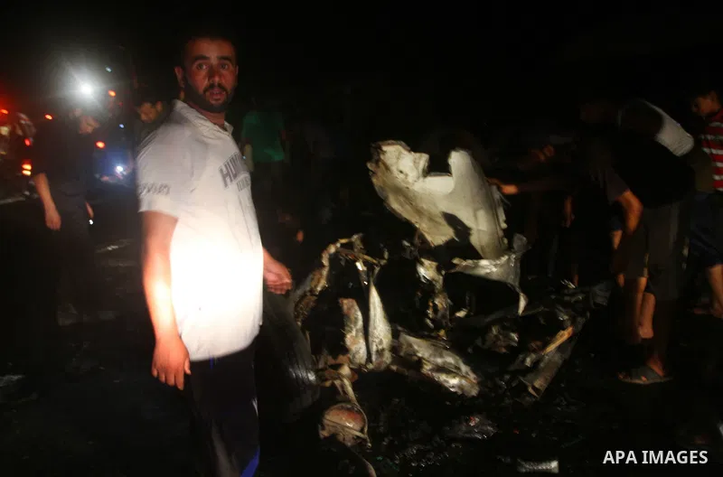 Palestinians check the damage to a car after an Israeli attack in Deir al-Balah in the central Gaza Strip on September 7, 2011. The hardline Islamic Jihad group said that the dead man, Remah al-Hasani, was a member of it...