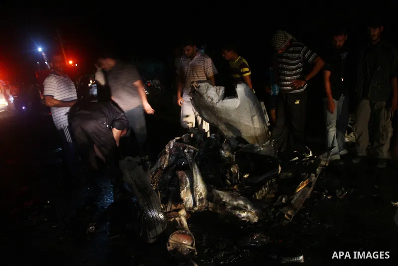 Palestinians check the damage to a car after an Israeli attack in Deir al-Balah in the central Gaza Strip on September 7, 2011. The hardline Islamic Jihad group said that the dead man, Remah al-Hasani, was a member of it...
