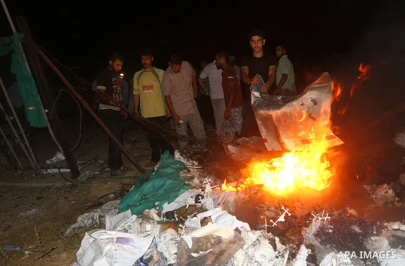 Palestinians check the damage to a car after an Israeli attack in Deir al-Balah in the central Gaza Strip on September 7, 2011. The hardline Islamic Jihad group said that the dead man, Remah al-Hasani, was a member of it...