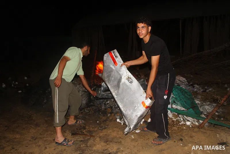 Palestinians check the damage to a car after an Israeli attack in Deir al-Balah in the central Gaza Strip on September 7, 2011. The hardline Islamic Jihad group said that the dead man, Remah al-Hasani, was a member of it...