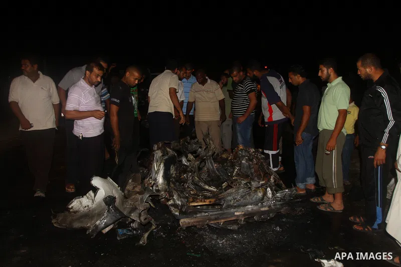 Palestinians check the damage to a car after an Israeli attack in Deir al-Balah in the central Gaza Strip on September 7, 2011. The hardline Islamic Jihad group said that the dead man, Remah al-Hasani, was a member of it...