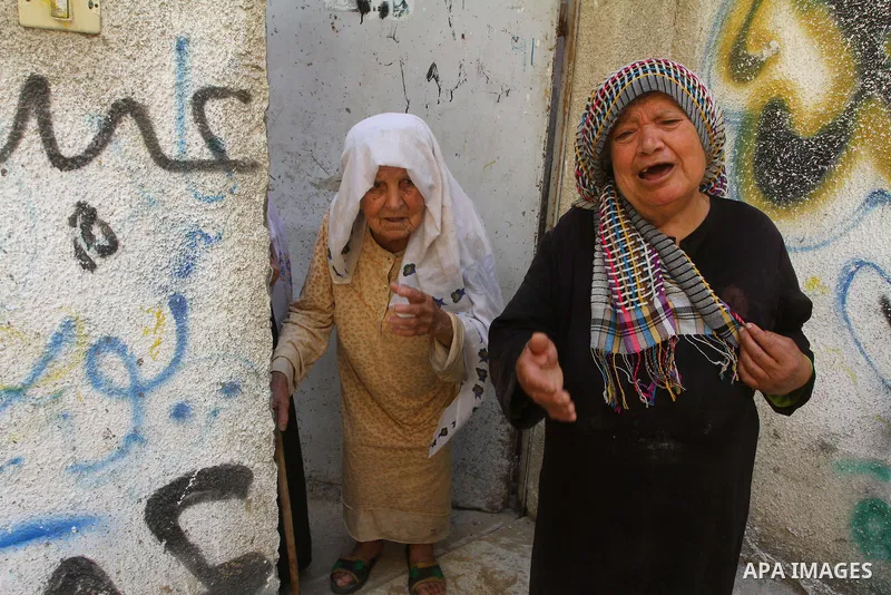 Relatives of the Palestinian member of its military wing the Al-Quds Brigades, Remah al-Hasani, mourn during his funeral in Gaza city on Sep. 8, 2011. He was killed as he was driving in the central Deir al-Balah district...