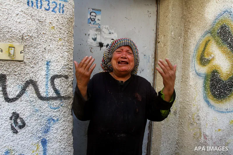 Relatives of the Palestinian member of its military wing the Al-Quds Brigades, Remah al-Hasani, mourn during his funeral in Gaza city on Sep. 8, 2011. He was killed as he was driving in the central Deir al-Balah district...