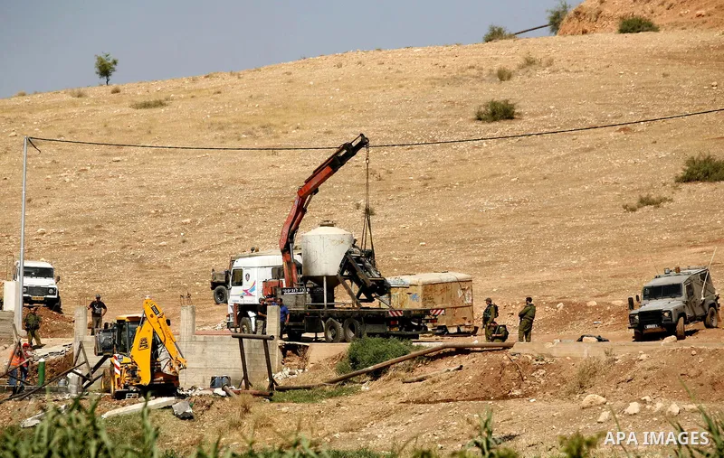 Israeli soldiers surround a bulldozer as it destroys a Palestinian water well in the northern West Bank village of Al-Nassariya, Thursday, Sept. 8, 2011. The Israeli civil administration told Palestinian residents in the...