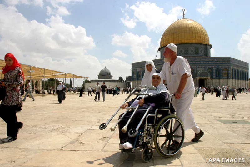 Palestinians walk in front of the Dome of the Rock after Friday prayers at the Al-Aqsa mosque compound in Jerusalem's old city on Sep. 9,2011. Photo by Mahfouz Abu Turk