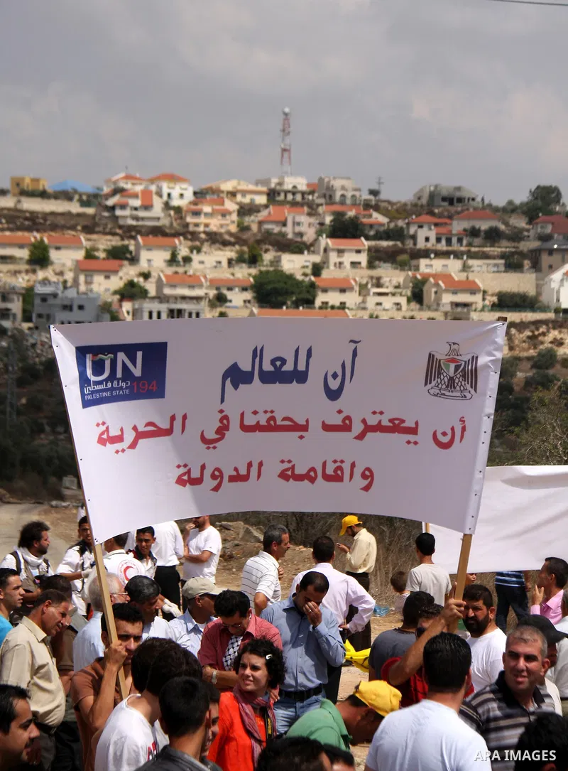Palestinians march towards the gate of Qadomim during the weekly protest against the settlement of Qadomim, near the village of Kofr Qadom, west of Nablus City, in the Israeli-occupied West Bank on 09 September 2011. Pho...