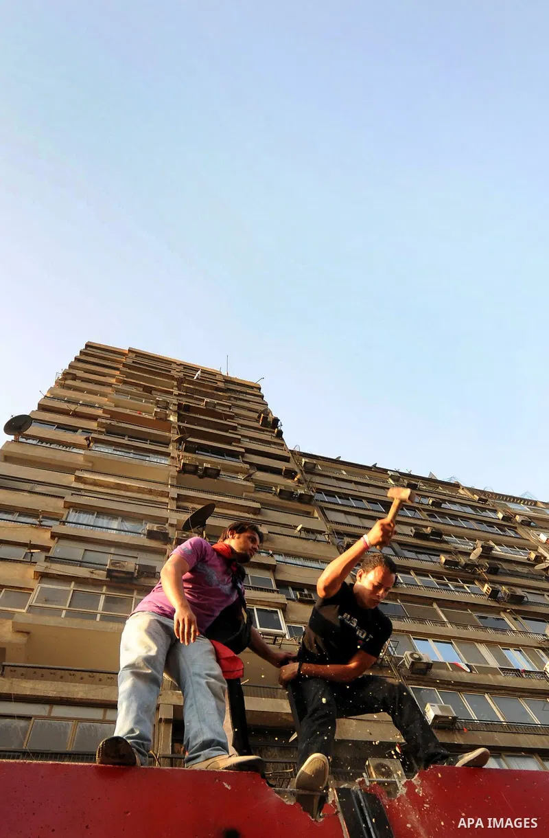 Egyptian protesters dismantle the concrete wall which was built in front of the Israeli embassy, in Cairo, Egypt, 09 September 2011. Security forces had built the wall in an attempt to secure the embassy after a series o...