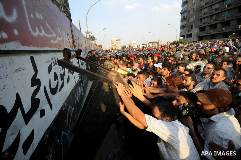 Egyptian protesters dismantle the concrete wall which was built in front of the Israeli embassy, in Cairo, Egypt, 09 September 2011. Security forces had built the wall in an attempt to secure the embassy after a series o...