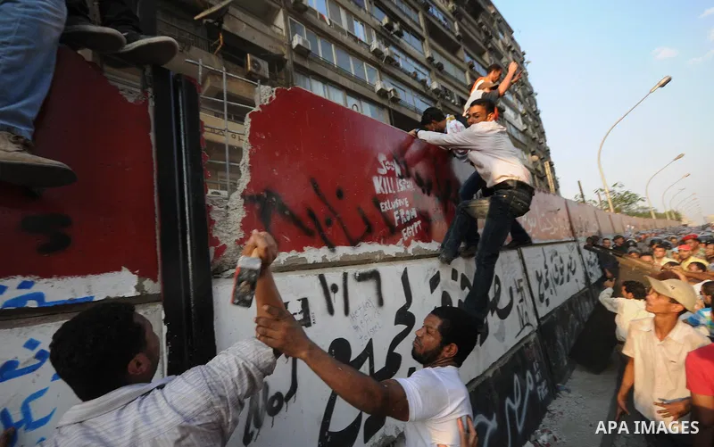 Egyptian protesters dismantle the concrete wall which was built in front of the Israeli embassy, in Cairo, Egypt, 09 September 2011. Security forces had built the wall in an attempt to secure the embassy after a series o...