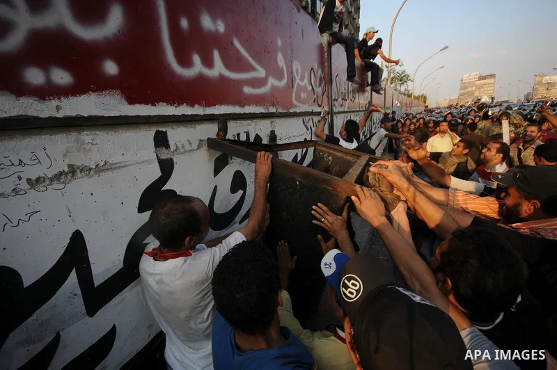 Egyptian protesters dismantle the concrete wall which was built in front of the Israeli embassy, in Cairo, Egypt, 09 September 2011. Security forces had built the wall in an attempt to secure the embassy after a series o...