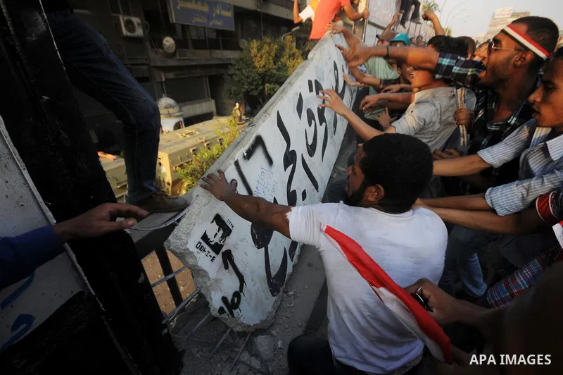 Egyptian protesters dismantle the concrete wall which was built in front of the Israeli embassy, in Cairo, Egypt, 09 September 2011. Security forces had built the wall in an attempt to secure the embassy after a series o...
